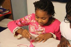 Local children used nail polish to color and varnish their lionfish fins before adding bows, bells, and sequins to create holiday ornaments.
