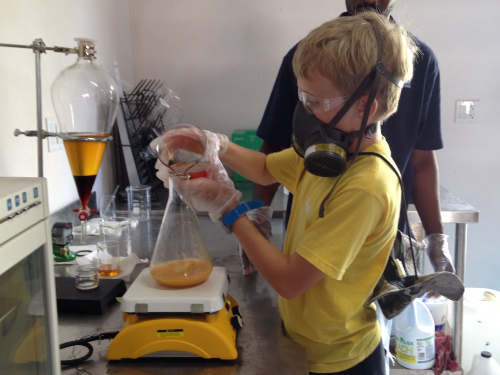 Student assisting Samuel our bio-diesel technician making a batch in the lab