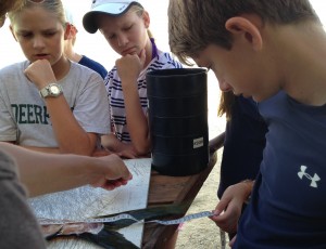 Students engaged in plastic pollution research getting up close with a mahi mahi dissection