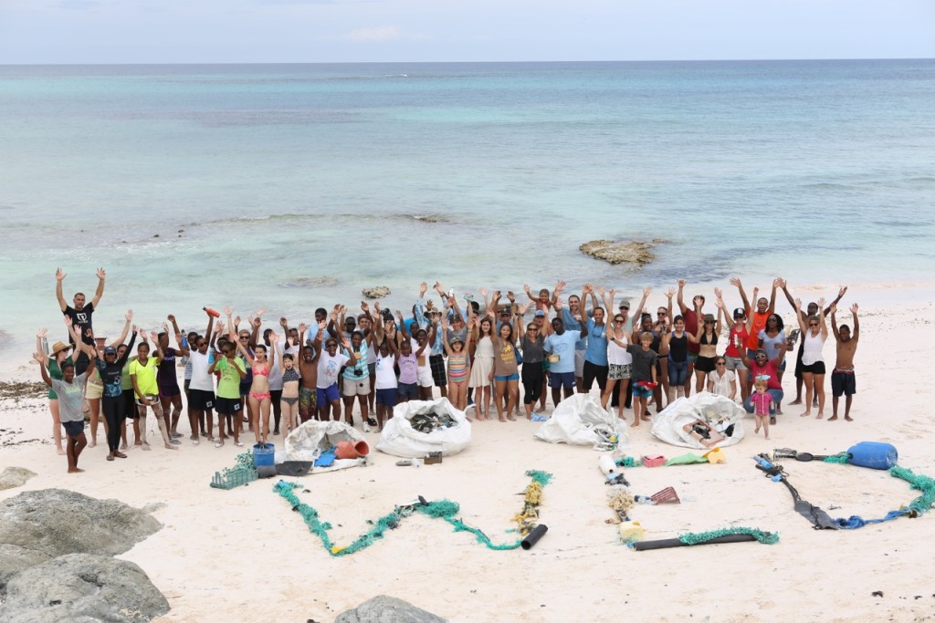 Summit attendees, 5 Gyres, and Jack Johnson celebrate World Environment Day on June 5 and show off all of the beach plastic they gathered.
