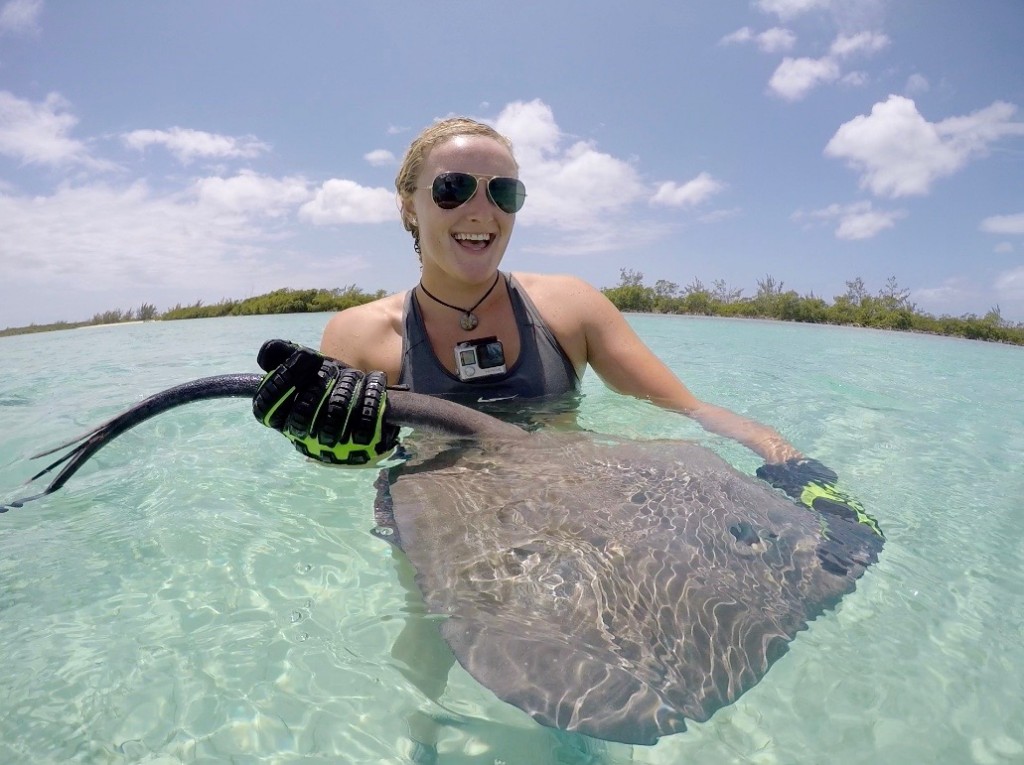 Shark Research and Conservation Programme intern Katie Luniewicz holds a juvenile Caribbean whiptail stingray before release